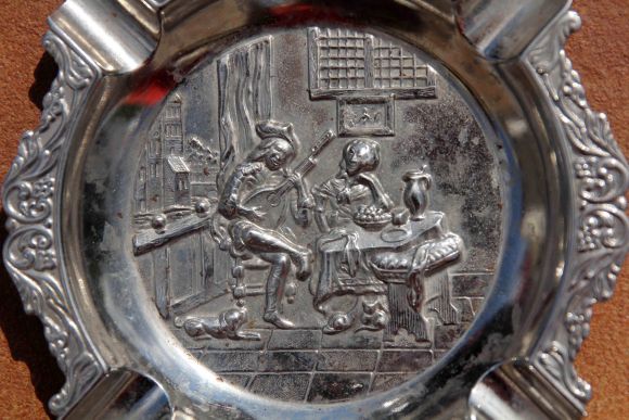 Металлическая пепельница с сюжетом о влюбленных.